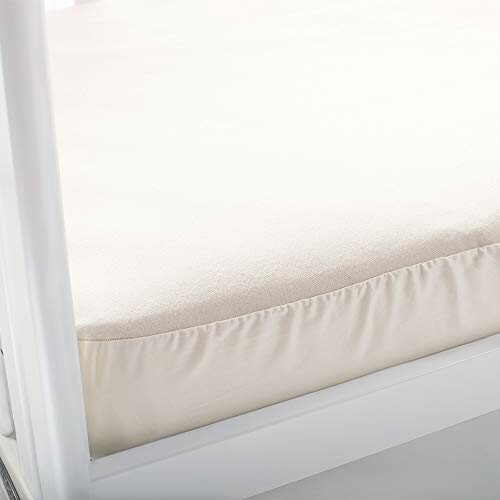 Beige fitted bed sheet on mattress.