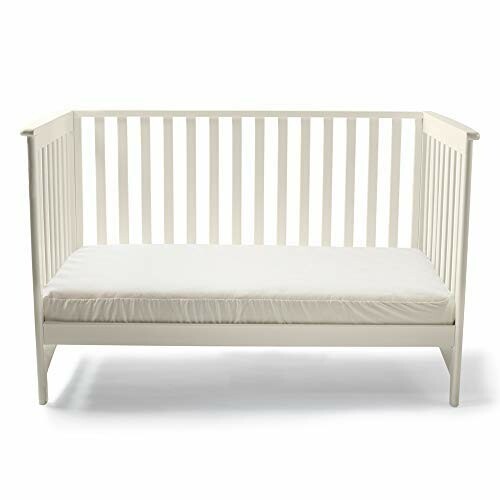 White toddler bed with mattress.