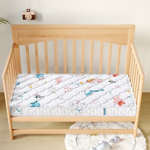 Wooden baby crib with a colorful patterned mattress.